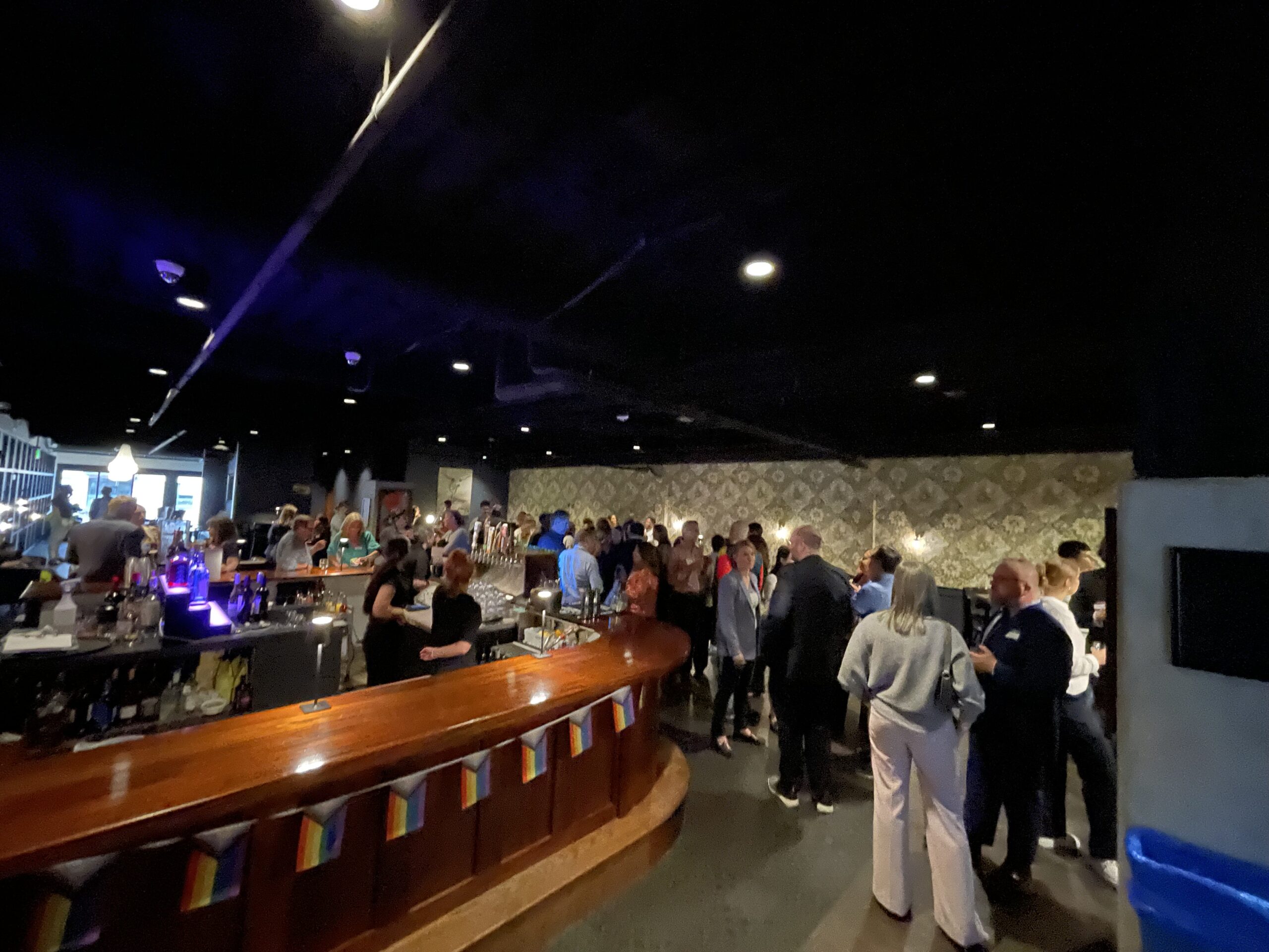 MLBA Happy Hour 2025 - board members at the bar with pride flags